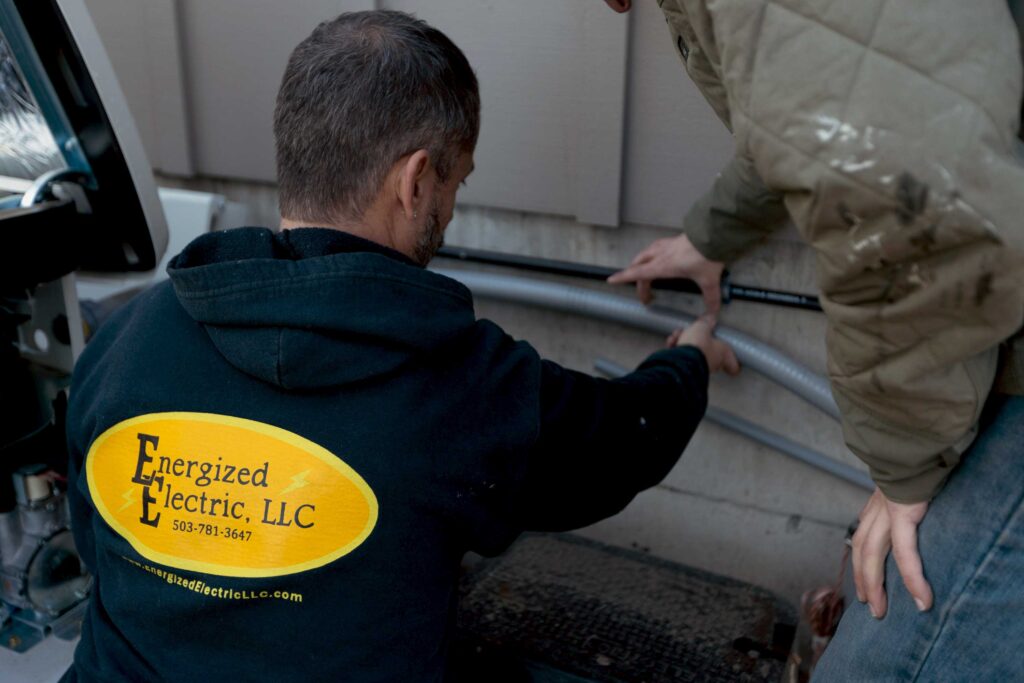 Two energized electric employees installing a pvc pipe
