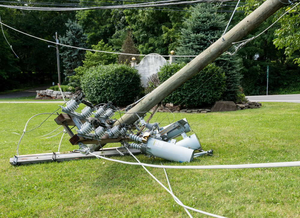 Snapped and downed power post outside of residential.