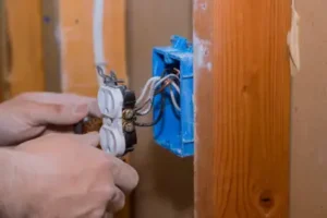 Energized Electric licensed electrician replacing an old outlet in a portland home