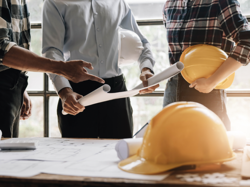 Professionals and engineers discussing overall construction plan